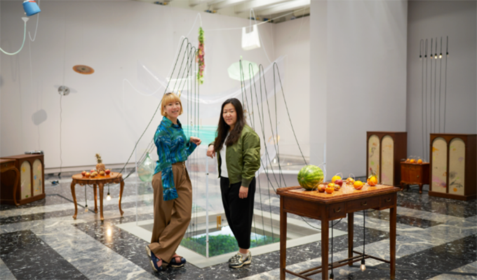 Two women chatting in the exhibition hall