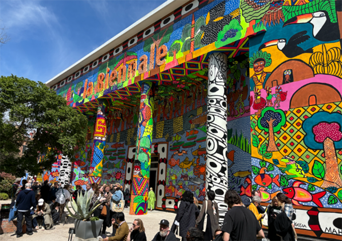 The entrance to the venue, decorated with colorful pillars and exterior walls where many people gather