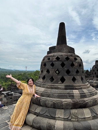 Misa Kono held by a temple stupa