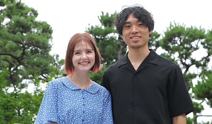 Amandine and Xuande are standing side by side, looking at us.